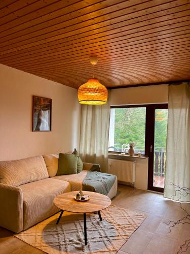 a living room with a couch and a table at Appartement 32 in Triberg