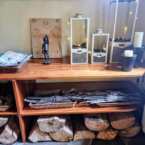 a wooden shelf with mirrors and a figurine on top at Altos Los Pioneros & Spa in Villa La Angostura