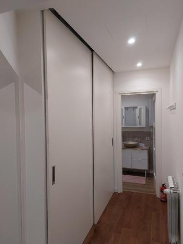 a room with white walls and a sliding door at Tuscan Ameliè in Borgo a Buggiano