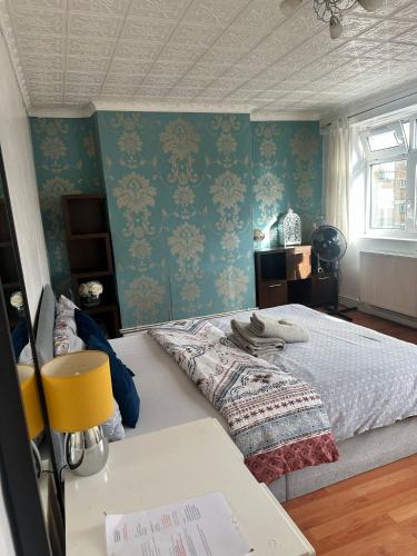 a bedroom with a bed and a desk in it at London Budget Maisonette in London