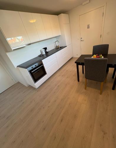 a kitchen and dining room with a table and a dining room gmaxwell gmaxwell gmaxwell gmaxwell at Temis apartment, private new 1 bed room and 1 living room with sofa bed and lagre kitchen, share with nobody in Oslo