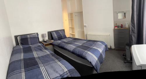 two beds in a small room with at Apple Tree Lodge in Bridlington