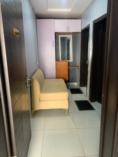 a small room with a chair and a door at Umbrella Properties hotels and apartments - Moniya in Ibadan