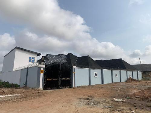 a building with a gate in front of it at Umbrella Properties hotels and apartments - Moniya in Ibadan