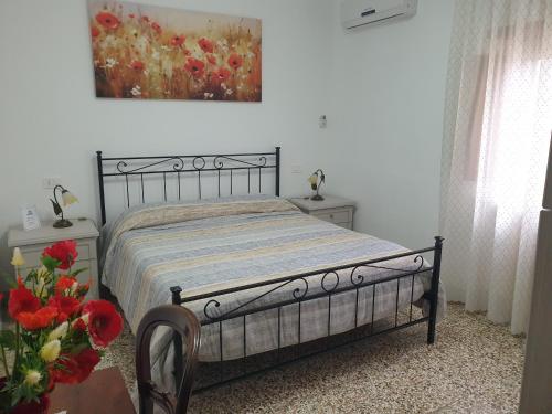 a bedroom with a bed and a painting on the wall at B&B Il Mandorlo in Cortona