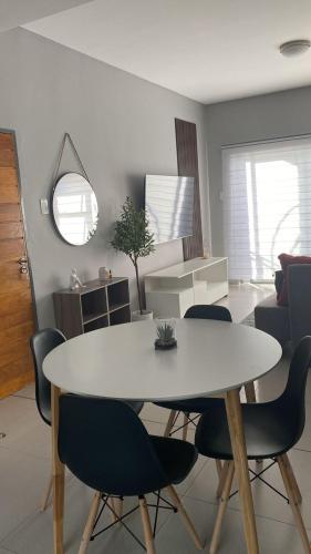 a white table and chairs in a living room at iThusi-CBD in Mbabane