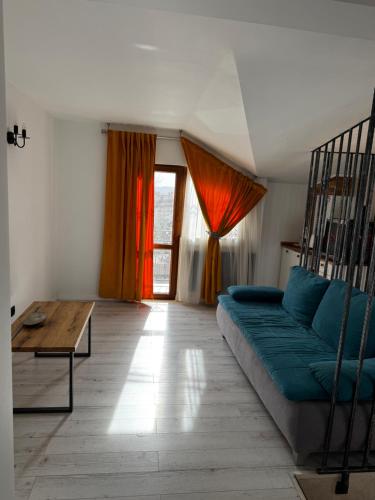 a living room with a couch and a table at Muz in Filiaşi