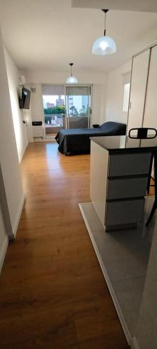 a large living room with a bed and a dresser at Departamento Barrio Martin in Rosario