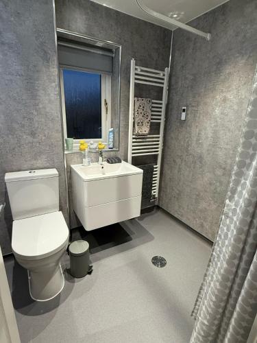 une salle de bain avec des toilettes blanches et un lavabo dans l'établissement Single room with beautiful garden, à Édimbourg