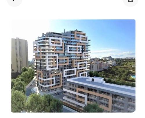 a view of a tall building in a city at Rocha T Apartments in Portimão