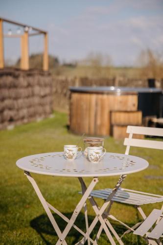 a white table with two cups on top of it at Chez Lilie in Le Sel