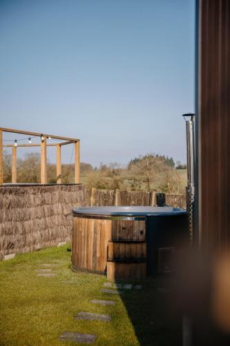 a swimming pool in a yard with a stone wall at Chez Lilie in Le Sel