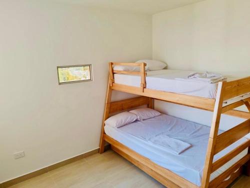 a bedroom with two bunk beds in a room at Ciudad Cristales in Villeta
