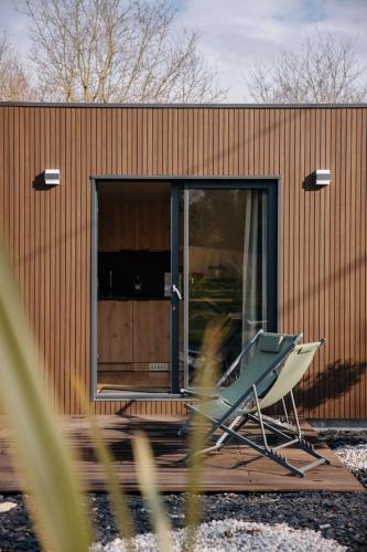 a building with a chair in front of it at Chez Lilie in Le Sel