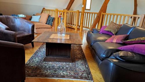 a living room with two couches and a coffee table at La Barde Montfort, votre maison d'hôtes à 4 kms de Sarlat Dordogne in Vitrac