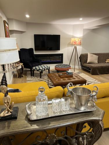 a living room with a yellow couch and a table at Luxurious Private Apartment in Oakville