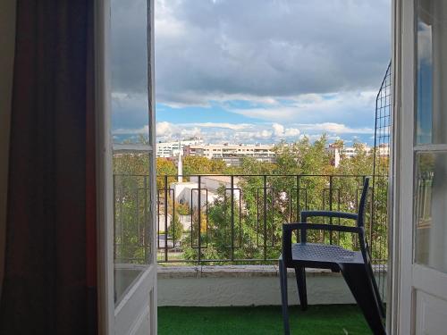 a chair on a balcony with a view of a city at Milena 4 in Lisbon