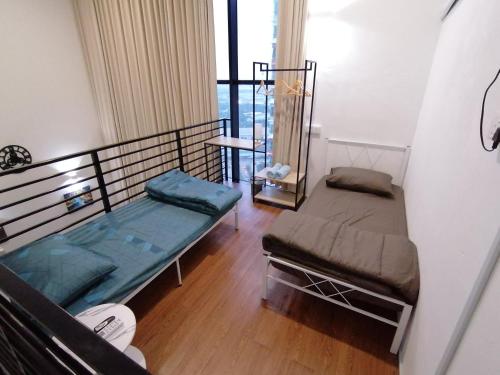 a room with two beds in a room at i-Duplex 1M2R2B Condo - LED Garden, Fun Fair, Waterpark, Wax Museum, Mall & More! in Shah Alam