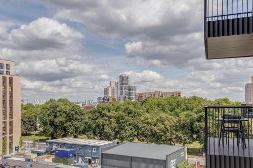 a view of a city with buildings and trees at Modern, Spacious 2bed, 2bath apartment in Barking in Barking