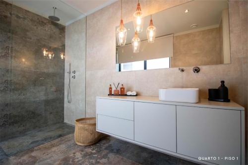 a bathroom with a white sink and a shower at Villa with Pool Casa Sol Poente by casaporto207 in Vila Verde