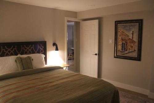 a bedroom with a bed and a picture on the wall at Luxurious Private Apartment in Oakville
