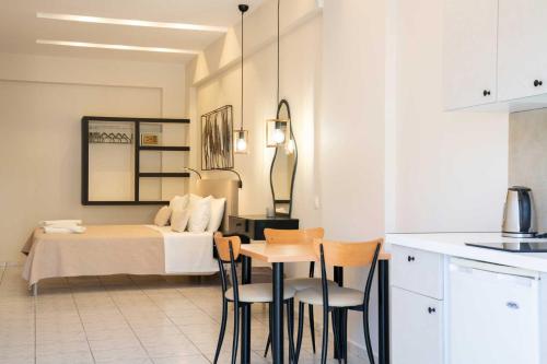 a bedroom with a bed and a table and chairs at Avenue Hotel Falassarna in Falasarna