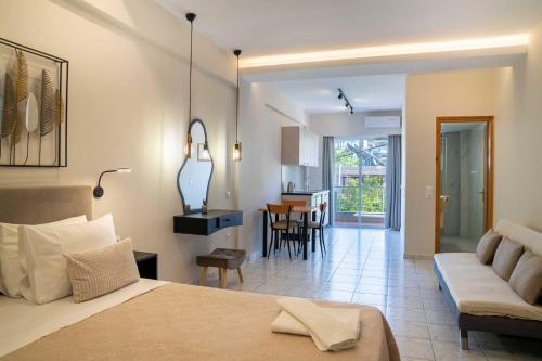a hotel room with a bed and a living room at Avenue Hotel Falassarna in Falasarna