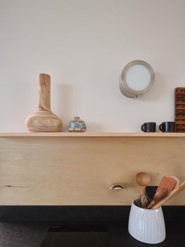 a room with a counter with a shelf with wooden spoons at The Martinsburg in Stonewall