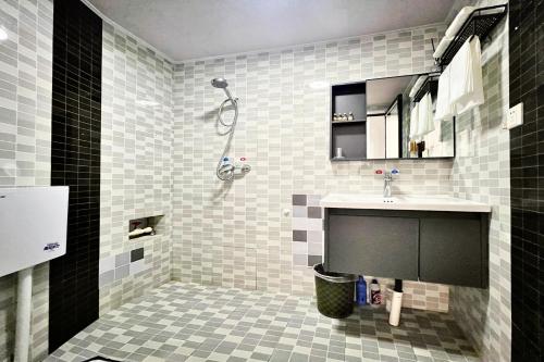 a bathroom with a sink and a shower at Nicer Family in Leshan