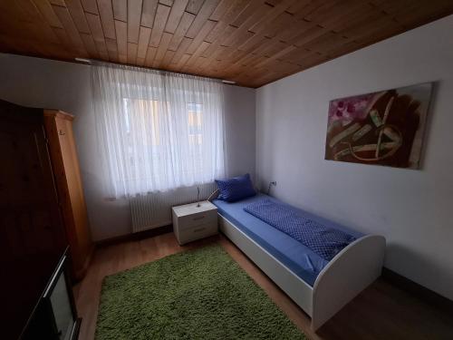 a small bedroom with a bed and a window at Haus - 4 Zimmer - 2 Bad - 1Küche, bis 8 Personen in Neuburg an der Donau