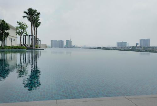 a swimming pool with a city in the background at Modern Sunsuria Forum 600mbps 5mins Setia City and SCCC in Shah Alam