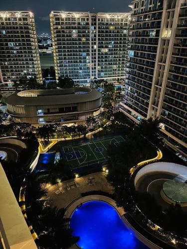 a large building with a tennis court in front of it at Azure staycation by marco in Manila
