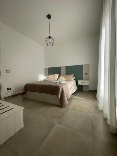 a bedroom with a bed and a pendant light at Paradise Rooms in Ripabottoni