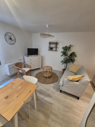 a living room with a couch and a table at Casa Paloma - Centre ville Arles in Arles