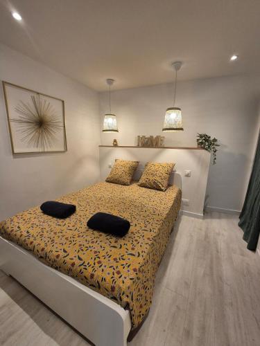 a bedroom with a bed with two pillows on it at Casa Paloma - Centre ville Arles in Arles
