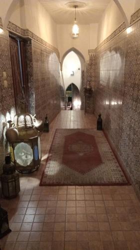 a hallway with a large rug on the floor of a building at Riad Carole - Perfect for Families & Groups in Marrakesh