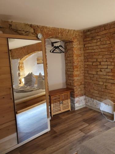a room with a mirror and a bed in it at Ferienwohnung Urlaubsbasis Renate in Zittau