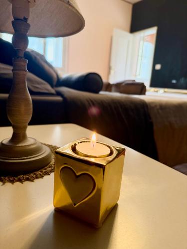 a candle sitting on a table in a living room at Esclusive Spa Suite in Comacchio