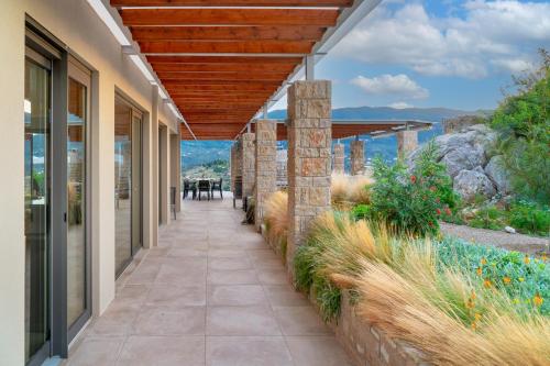 a walkway leading to a house with a view at Mar-A-Poros in Poros