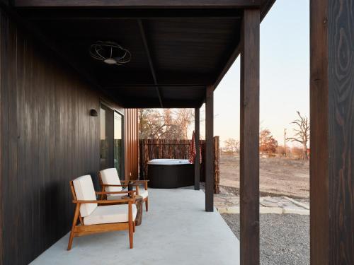 a porch of a house with two chairs and a table at The Martinsburg in Stonewall