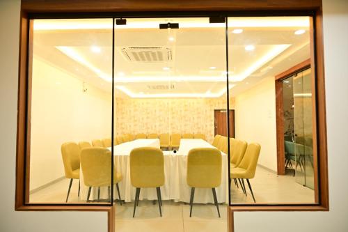 a conference room with a table and chairs at Manthra Hotel, Basavakalyan in Basavakalyān