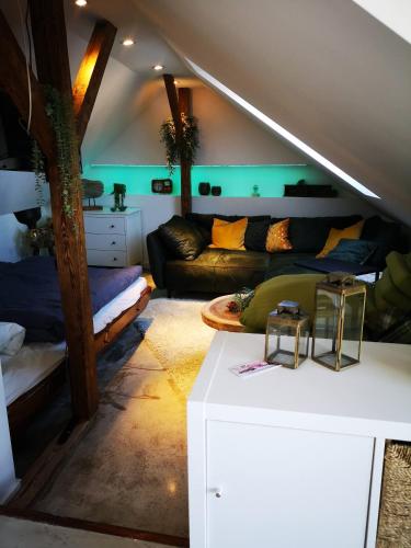 a living room with a couch and a table at Ferienwohnung mit Rheinblick in Kalkar