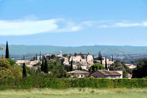 a town with houses and trees in a field at Maison Les Chênes - Jacuzzi - Calme & Idéalement situé - Clim - Salle de Jeux - Parking in Sauzet