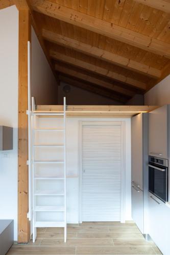 a room with a loft bed in a kitchen at Apartments and holidays Cav Chiara Tione di Trento in Tione di Trento