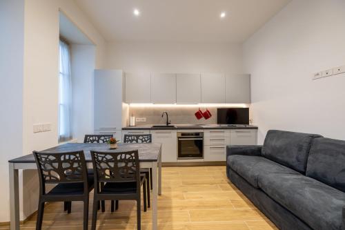 a living room with a table and a couch at Apartments and holidays Cav Chiara Tione di Trento in Tione di Trento