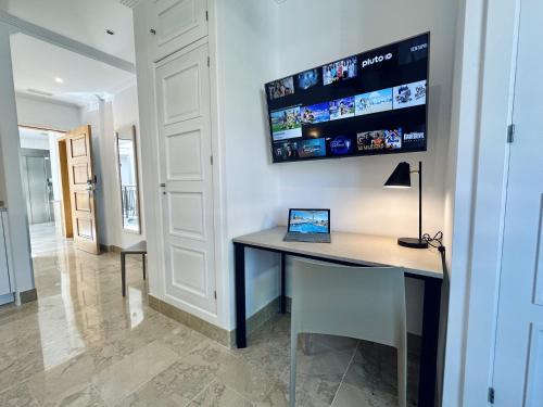 a home office with a desk and a lamp at Hotel Apartamentos Marina Luz in Chipiona