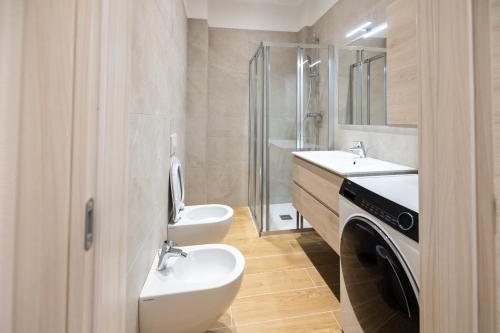 a bathroom with a sink and a toilet and a shower at Apartments and holidays Cav Chiara Tione di Trento in Tione di Trento