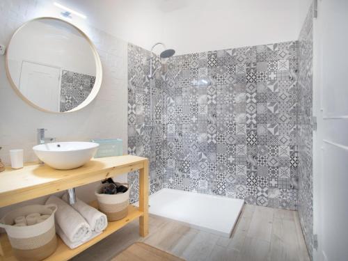 a bathroom with a sink and a mirror at Boho house, Albufeira in Albufeira