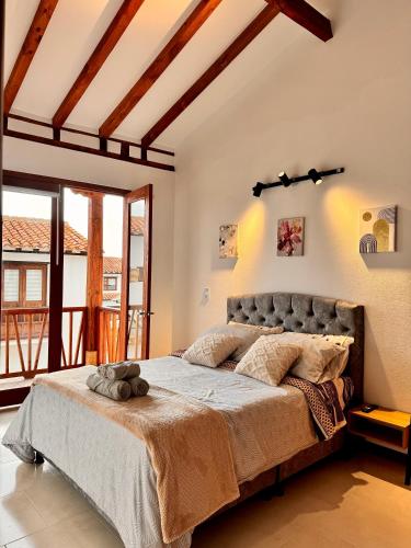 Ένα ή περισσότερα κρεβάτια σε δωμάτιο στο Refugio encantador en la Villa de Leyva