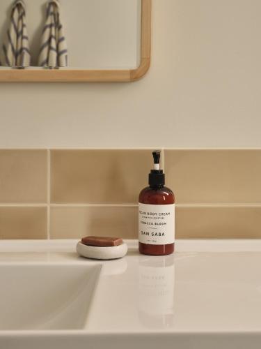 a bottle of soap sitting on top of a bathroom sink at The Martinsburg in Stonewall